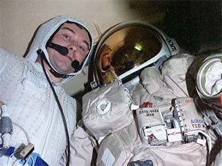 Dezhurov poses with space suit.